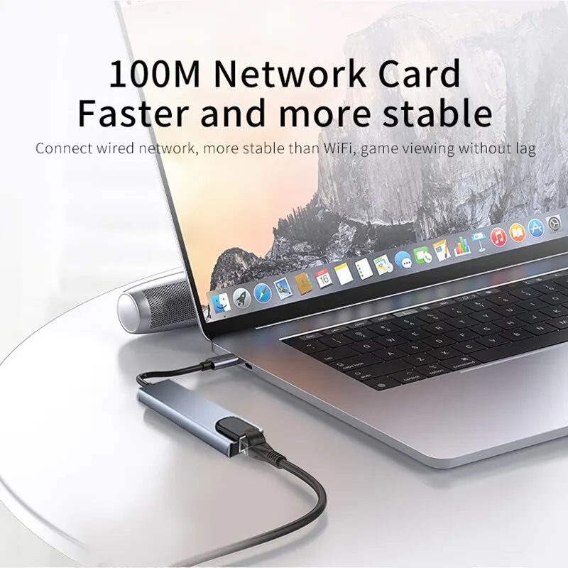 A slim USB-C hub with several ports connected by one cable to a laptop